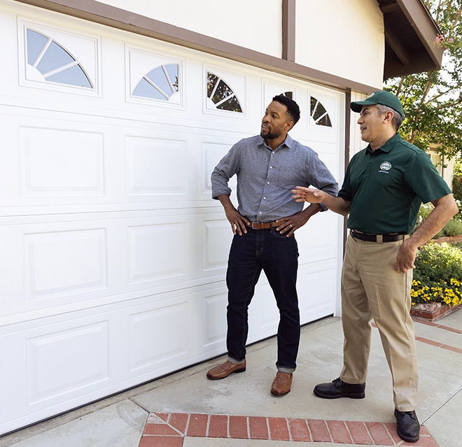 Technicians examining a garage door